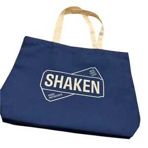 Blue canvas tote with cream handles. NEW